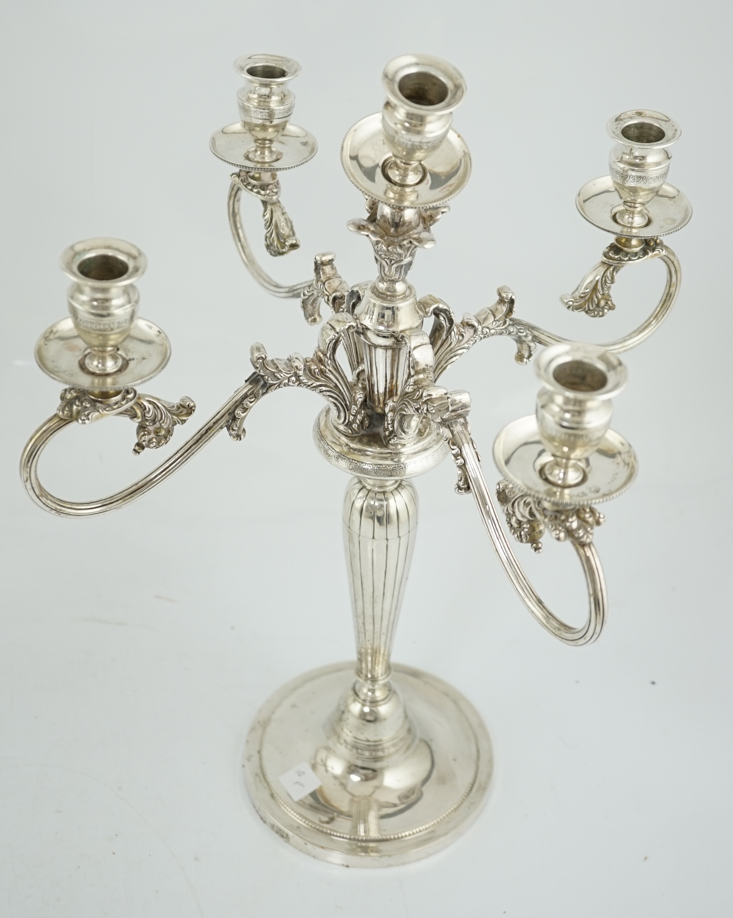 A pair of late 19th century Russian 84 zolotnik four branch, five light candelabra